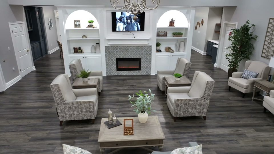 Living room at Silverleaf at Bee Cave with a tiled fireplace and arched white built in shelving
